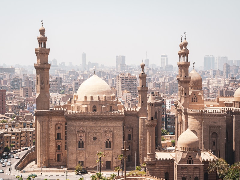 Pedestrian Al-Muizz Street with the minaret of Qalawun complex